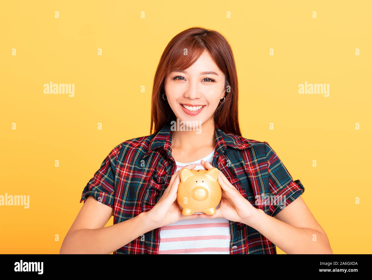 beautiful smiling young asian woman showing piggy bank Stock Photo - Alamy