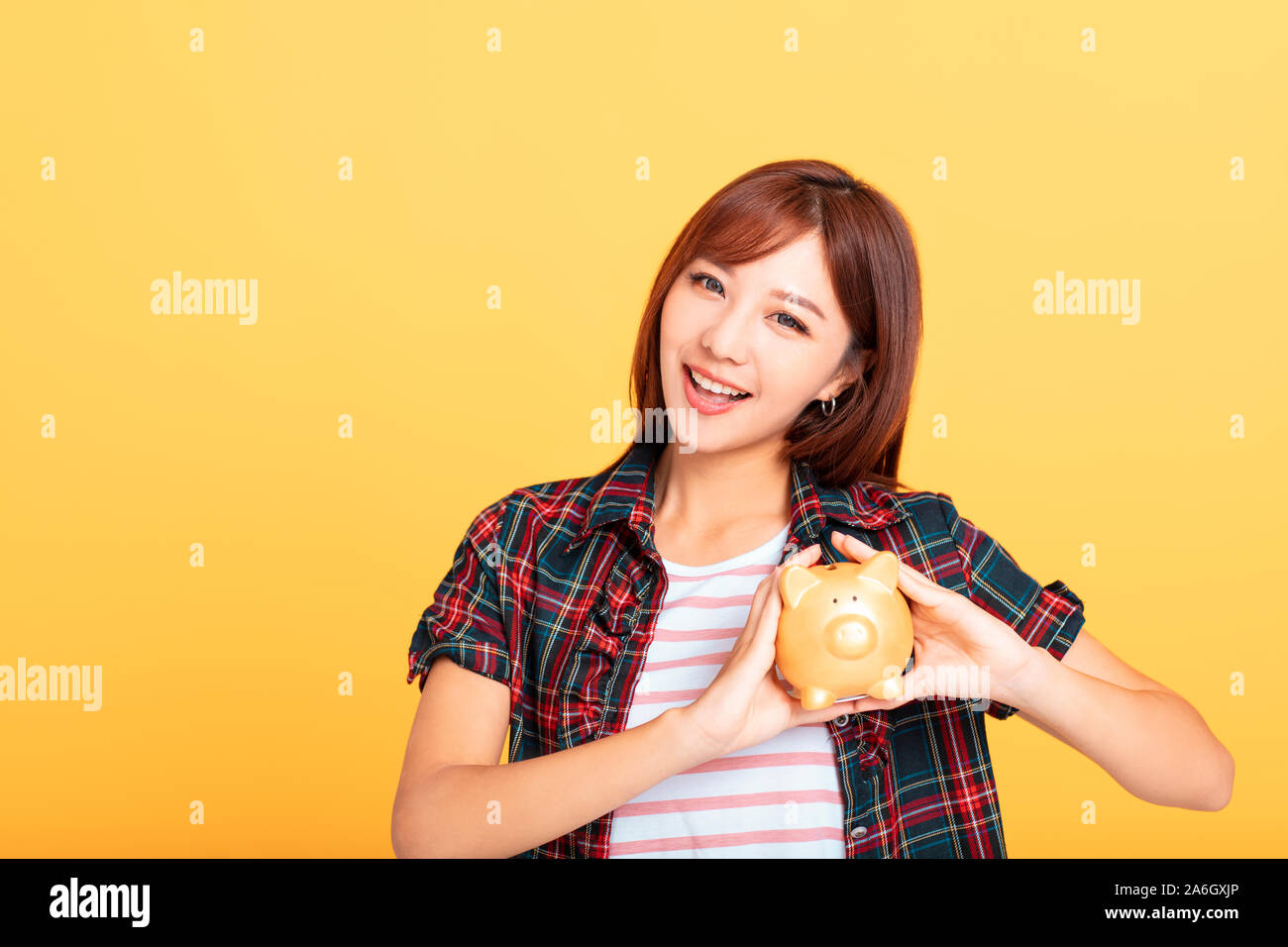 beautiful smiling young asian woman showing piggy bank Stock Photo - Alamy