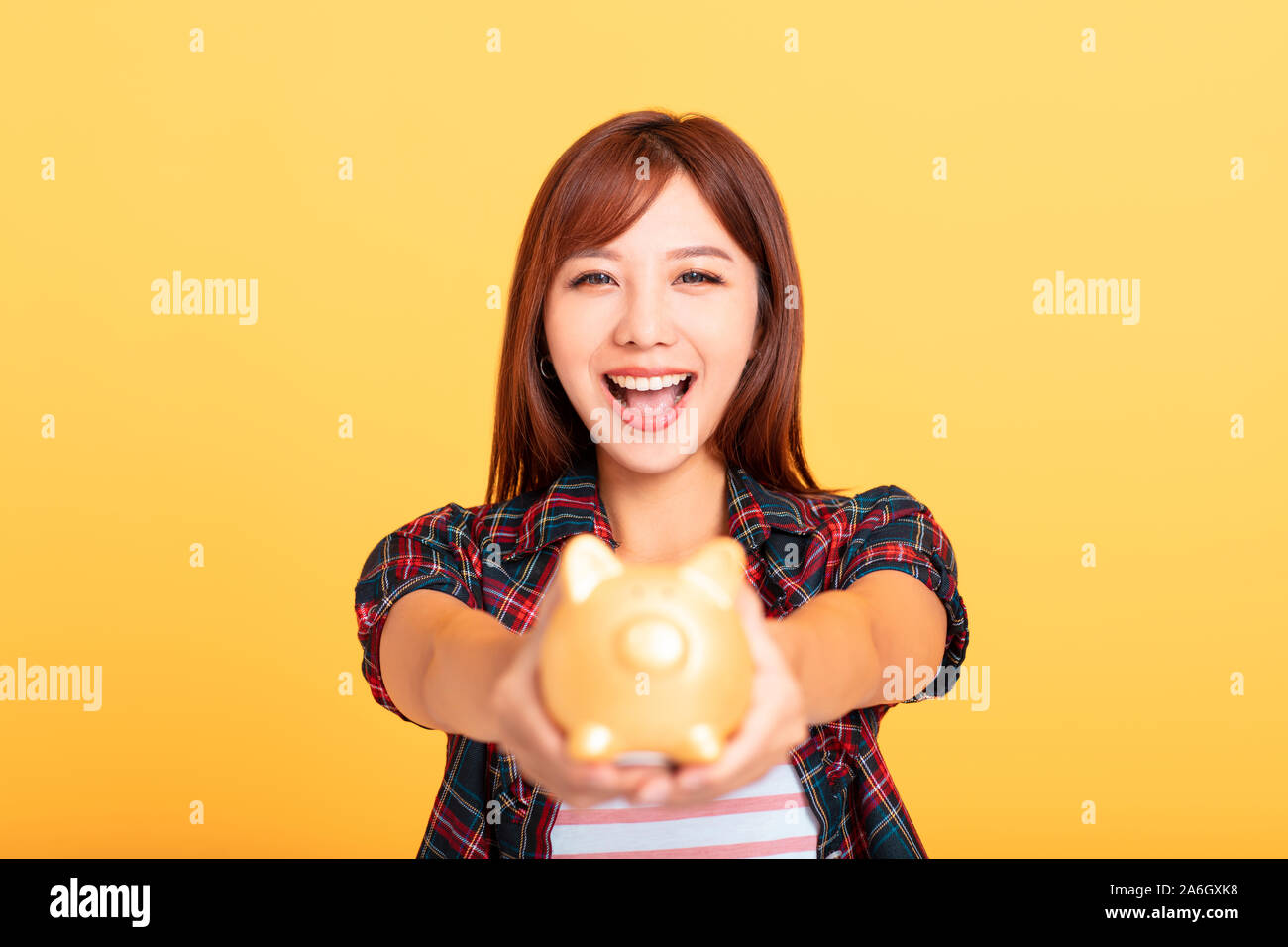 beautiful smiling young asian woman showing piggy bank Stock Photo - Alamy