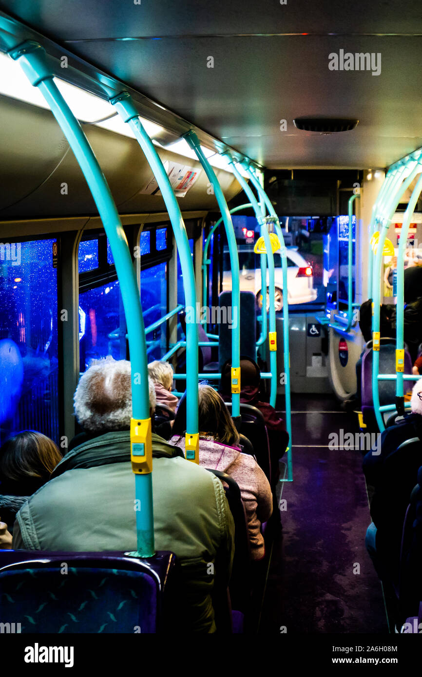People seated on a bus at night time taking a journey from Longton to ...