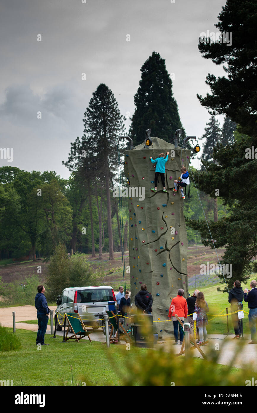 People try their hands at climbing on a huge mobile outdoor climbing wall at Trentham Gardens, Stoke on Trent Stock Photo