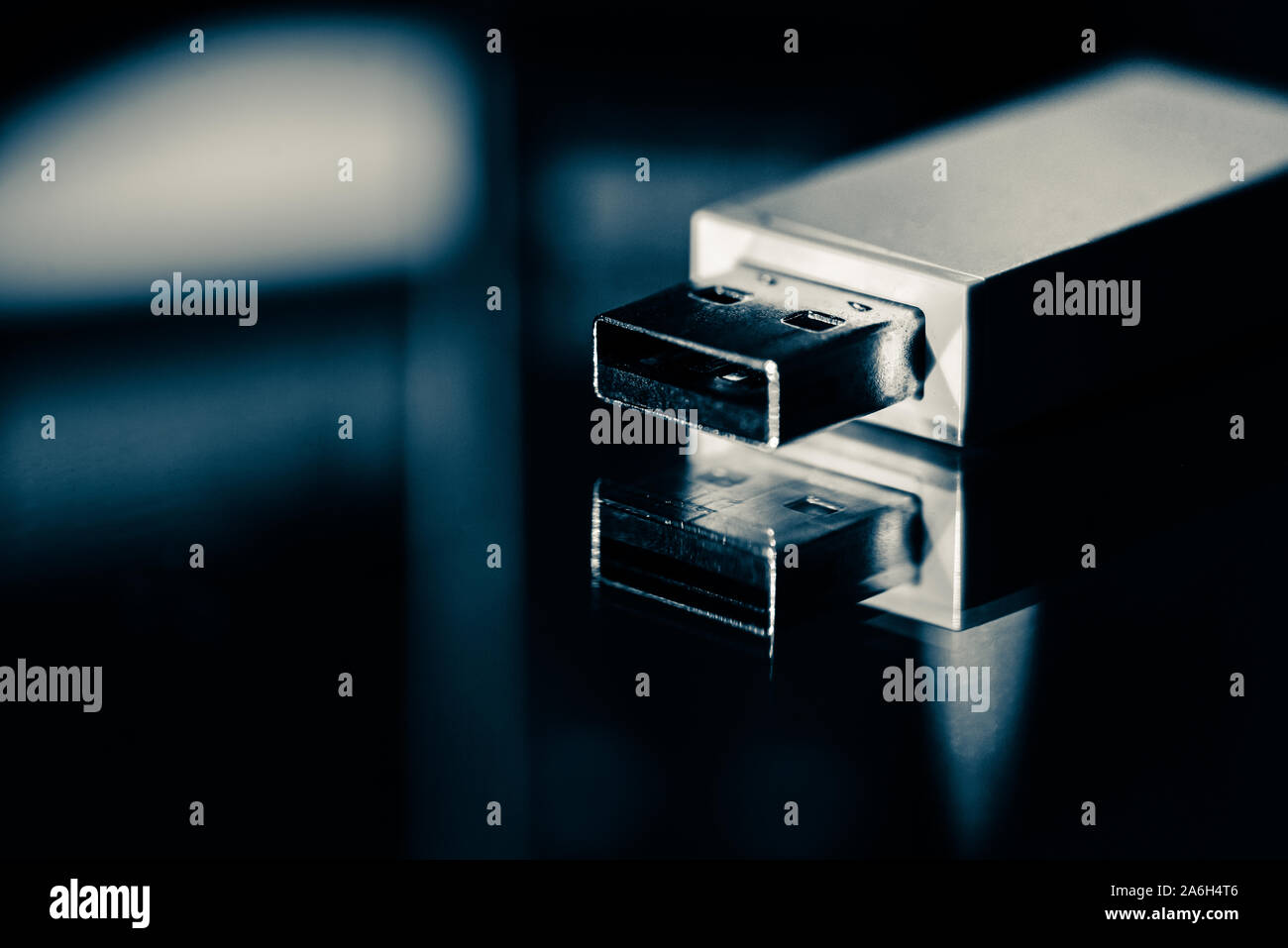 USB memory stick, bluetooth connection adapter on a mirrored background with studio lighting, close up Stock Photo