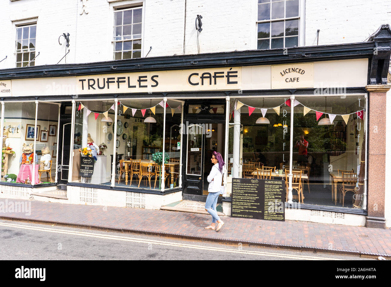 A shopper walks past the Truffles Cafe in the Iron Bridge High Street