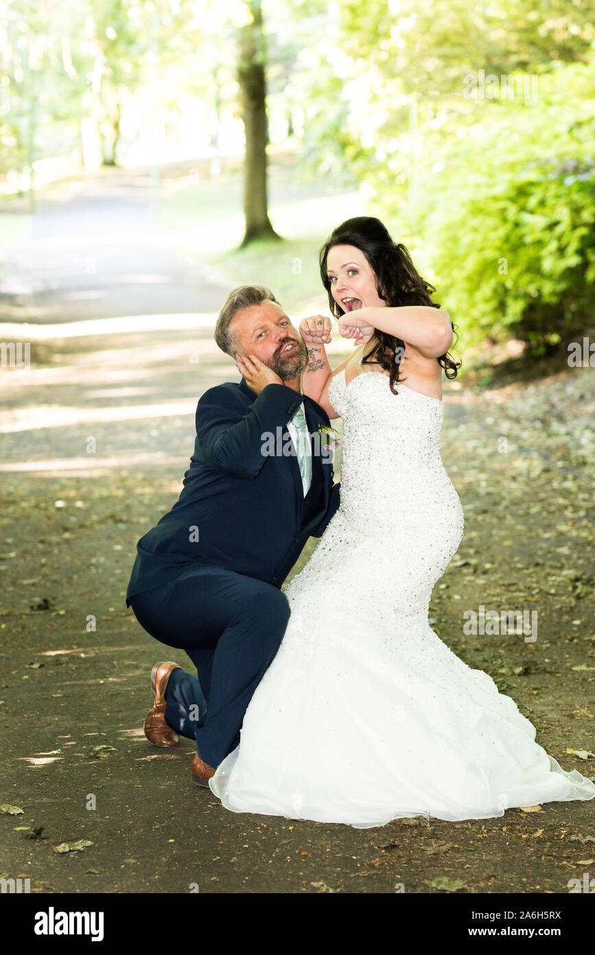 A bride and her brother pose for a funny picture, funny wedding pictures,  posing Stock Photo - Alamy