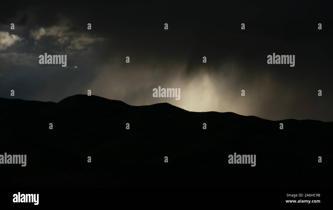 dark stormy sky over mountain range silhouette Stock Photo