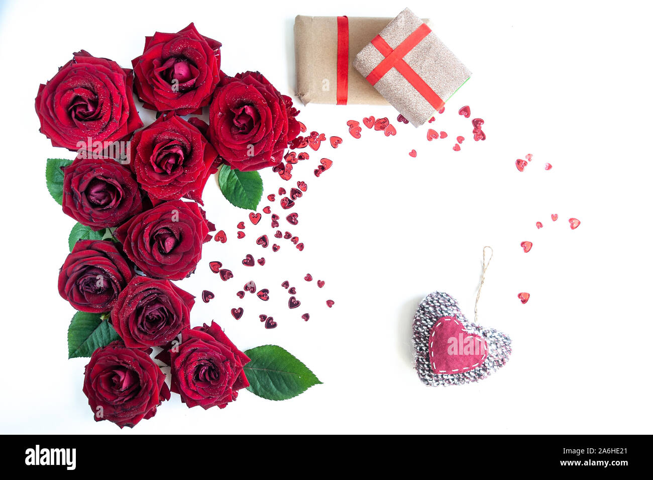 Flat Lay Background, flower pattern, Valentine's Day, the theme of lovers. Red roses and gifts with ribbons on a white background, isolated Stock Photo