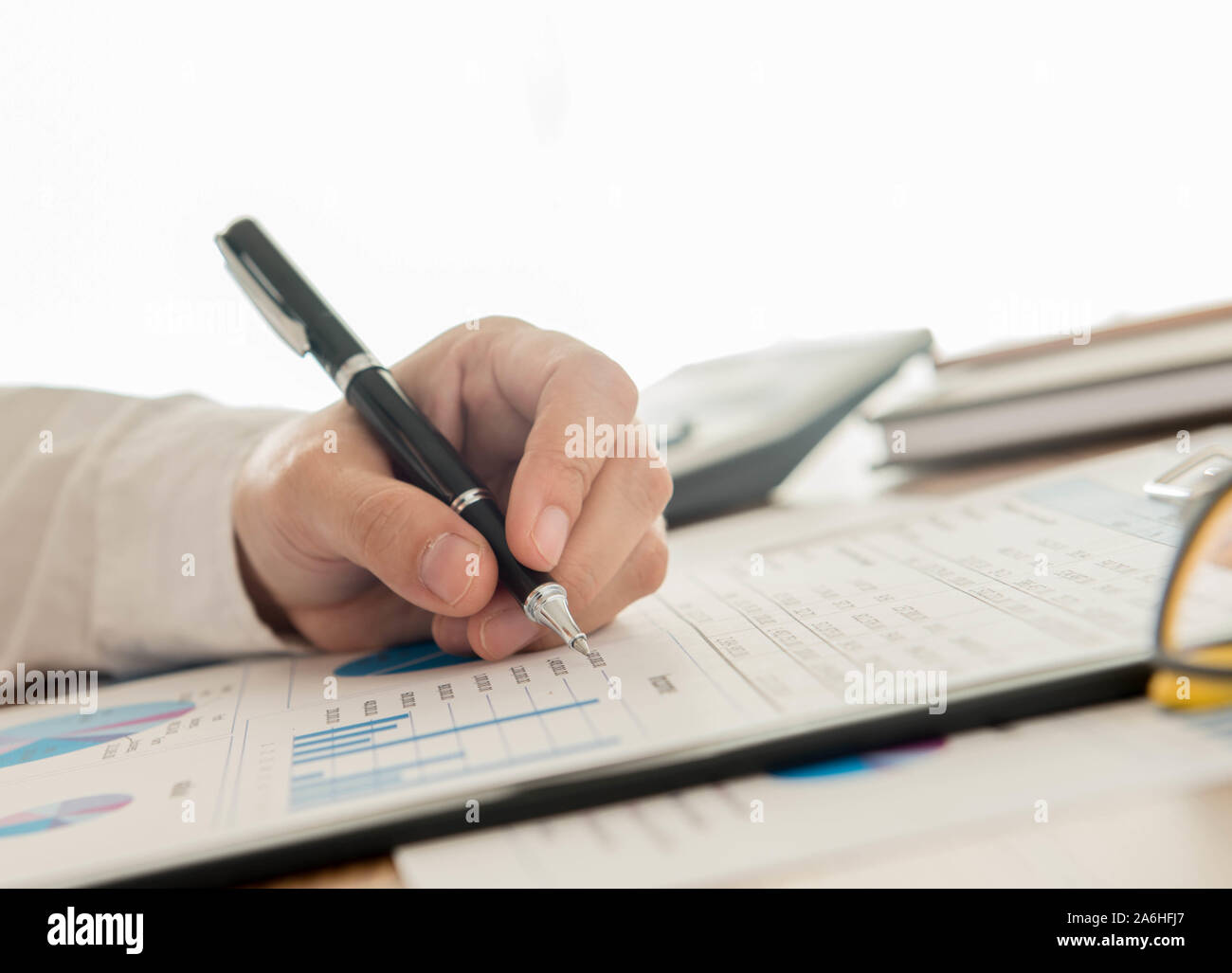 Businessmen are analyzing data from graph reports. Stock Photo