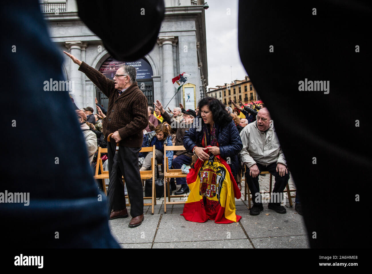 Pro Franco and fascism supporter salutes during the rally. Every November 20th, hundreds of Franco regime supporters march in a rally to celebrate and honour the dictator's death (on November 20th, 1975). During the rally, three FEMEN activists irrupted demanding that fascist demonstrations should be legalised in Spain. They were attacked by demonstrators and one man was detained. Stock Photo