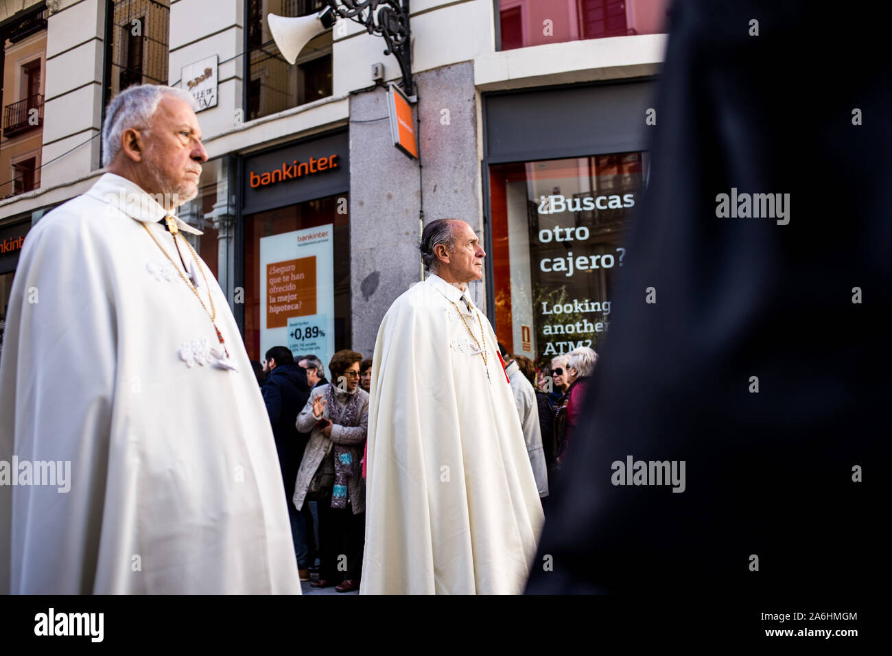Catholic priests during the procession. Virgin Almudena procession happens through the streets of Madrid where the saint patron of the capital of Spain is carried from Plaza Mayor to Almudena's Cathedral. Hundreds of catholic congregations join the procession to honour the virgin. Stock Photo