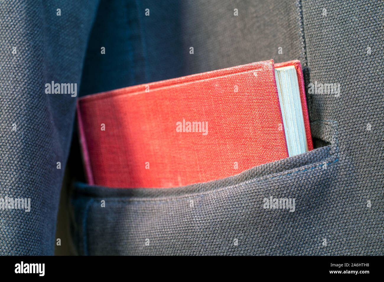 red book in a jacket pocket Stock Photo