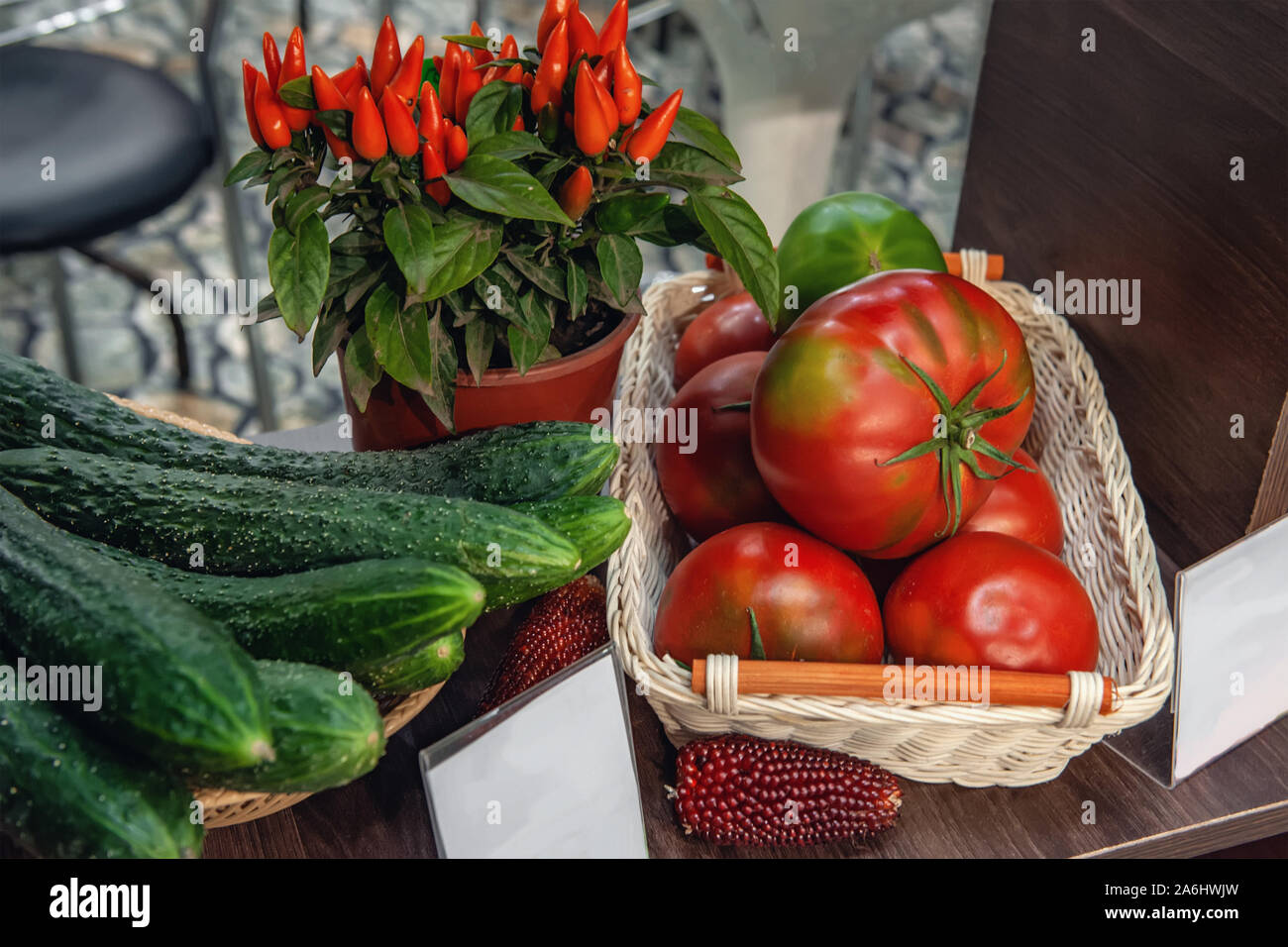 Farm vegetables cucumbers, tomatoes and hot chili peppers are in the
