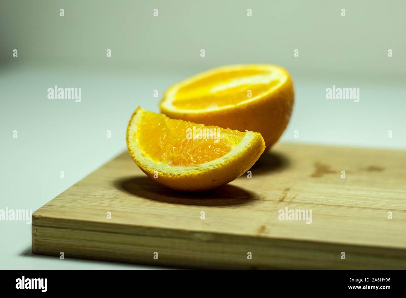 Large oranges cut on a chopping block Stock Photo