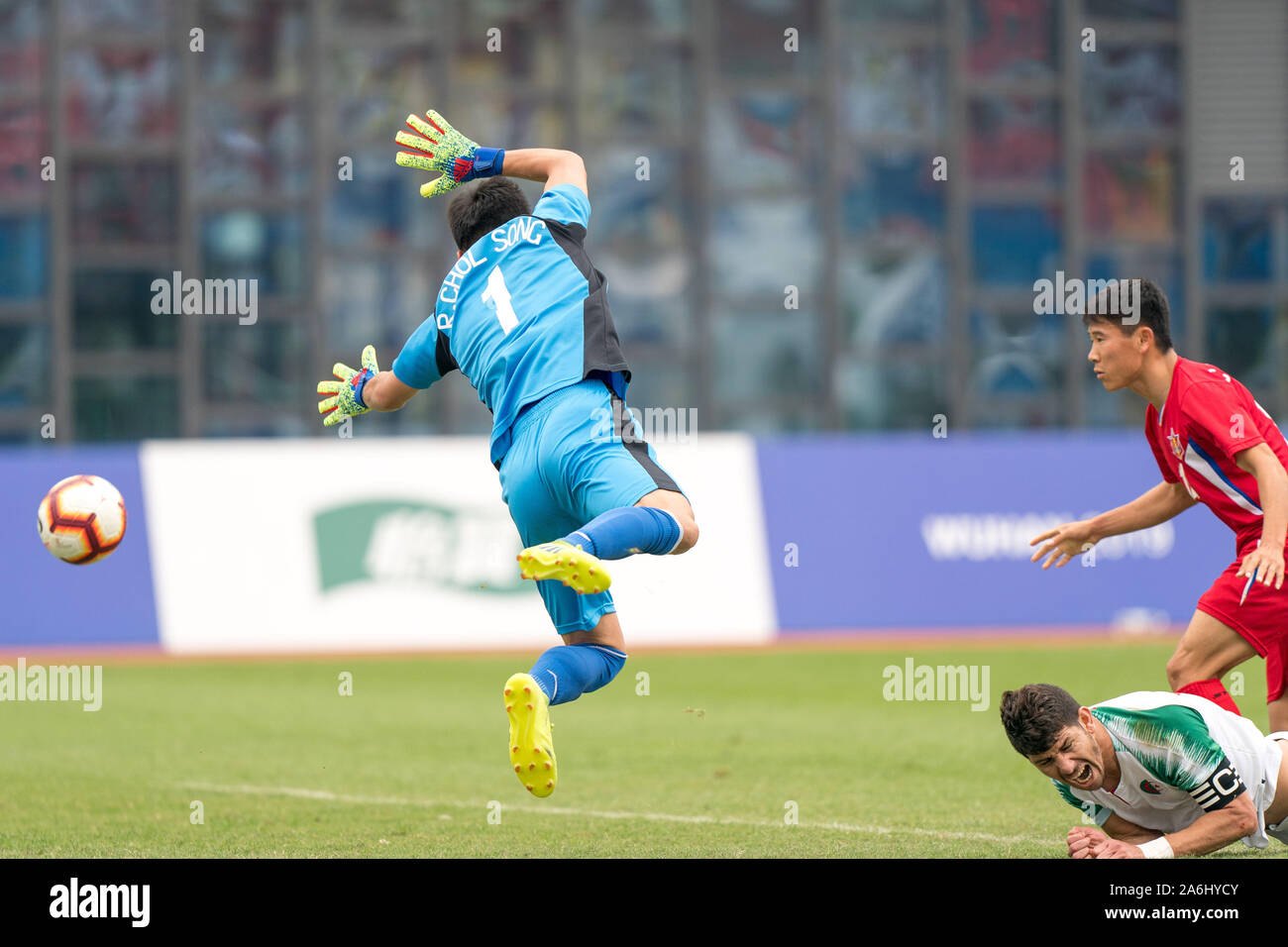 Wuhan, China. 27th Oct, 2019. Goalkeeper Ri Chol Song (L) of the Democratic People's Republic of Korea (DPRK) makes a save during the men's football bronze medal match between Algeria and the DPRK at the 7th International Military Sports Council (CISM) Military World Games in Wuhan, capital of central China, Oct. 27, 2019. Credit: Liu Jinhai/Xinhua/Alamy Live News Stock Photo
