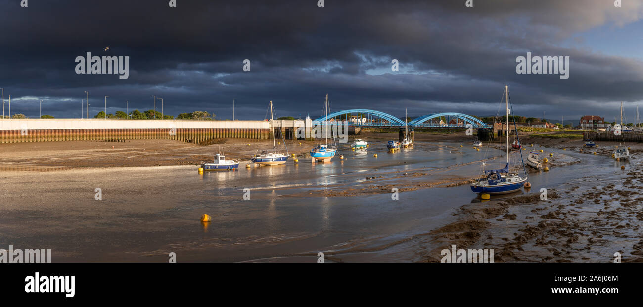 Panoramic view of Rhyl harbour at low tide under stormy skies Stock Photo