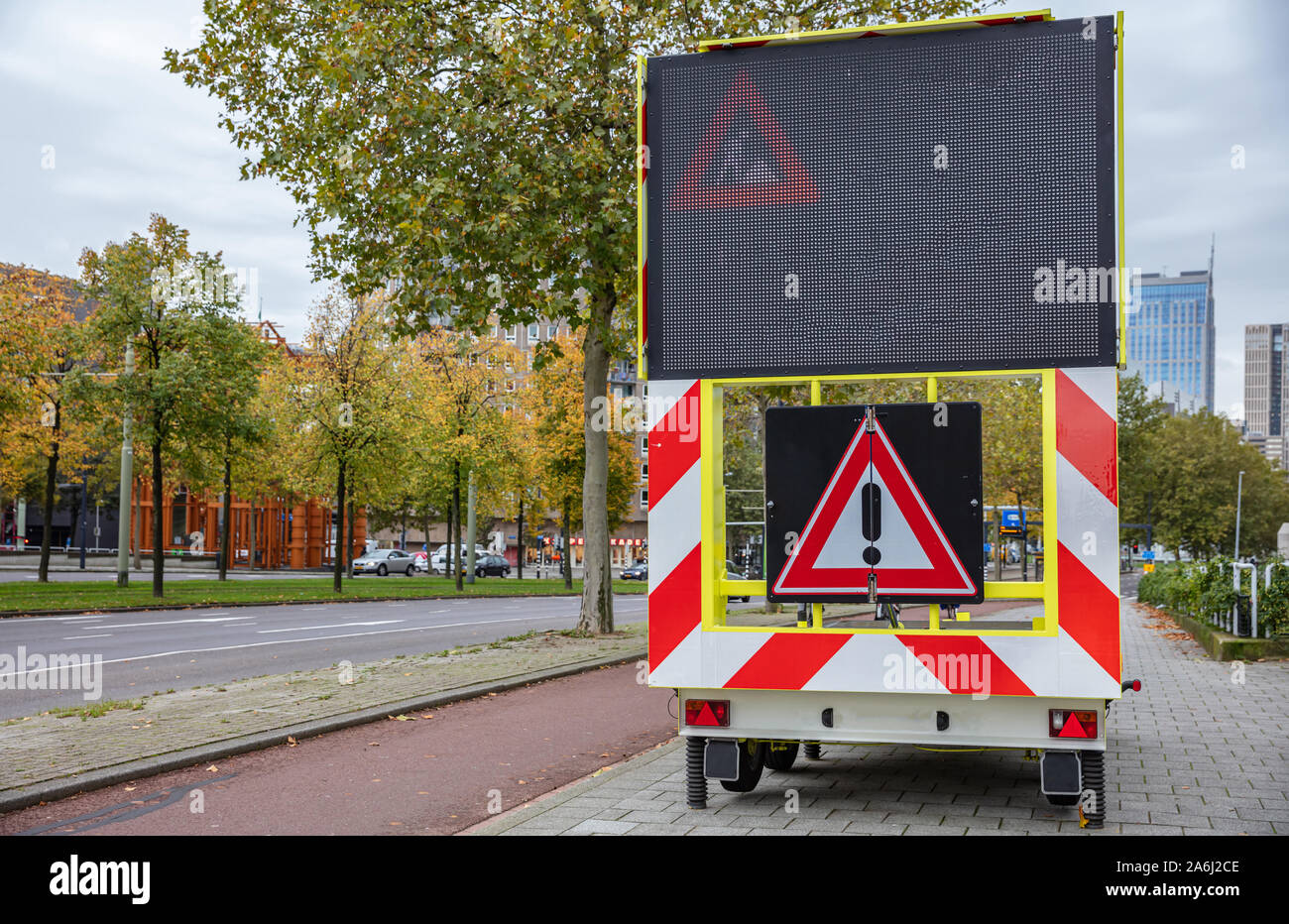 Roadworks warning signage, led lights board and danger exclamation sign on a trailer the city center, cloudy autumn day Stock Photo Alamy