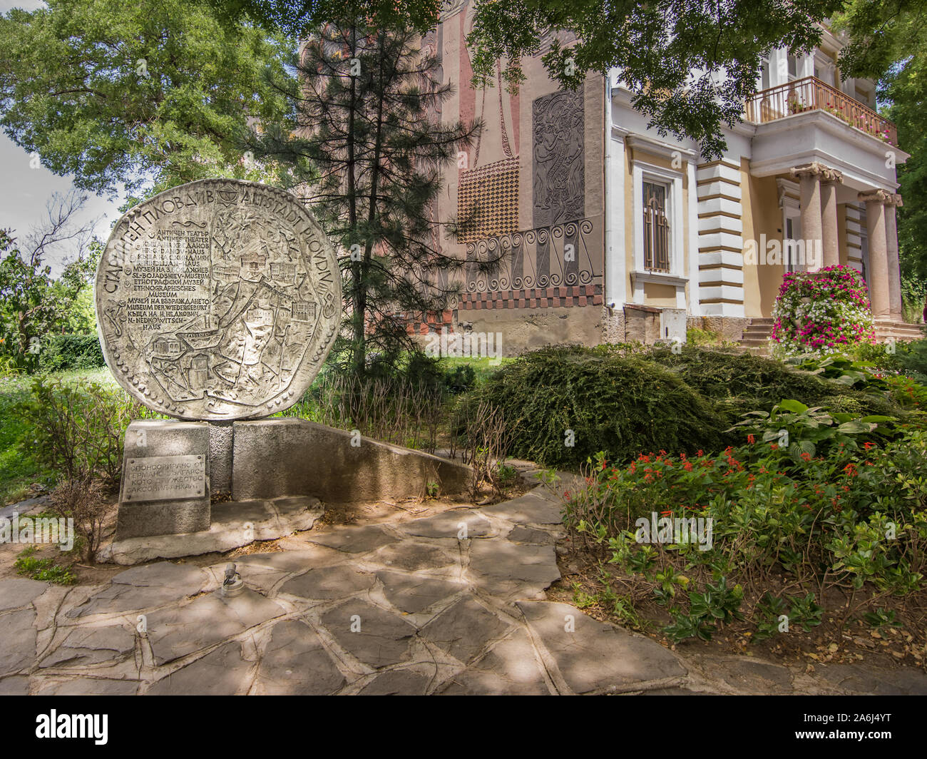 PLOVDIV, BULGARIA - 22 June 2019: wheel-shaped stone monument with inscriptions in front of the Academy of Music Dance and Fine Arts in Plovdiv Stock Photo