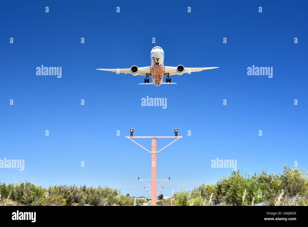 Qantas Boeing 787 Dreamliner VH-ZND on approach to Perth Airport flying over approach lighting. Stock Photo