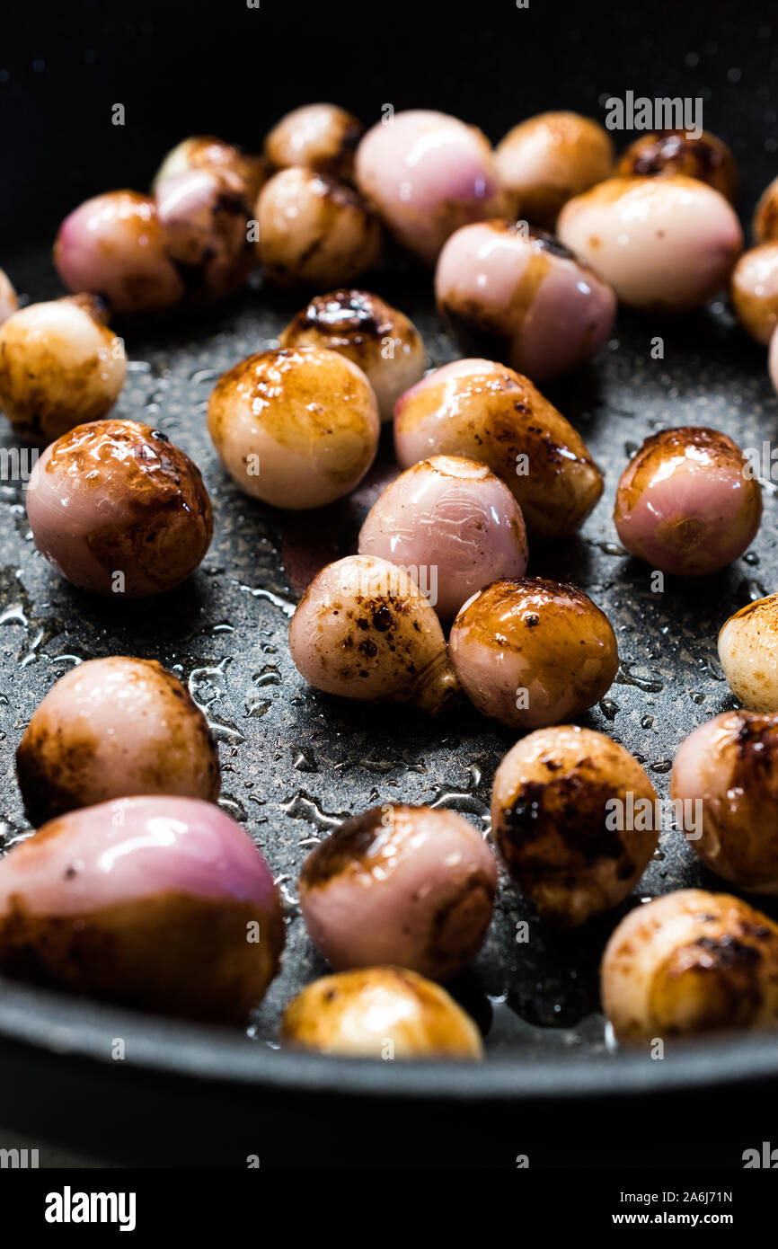 Homemade Roasted Shallots with Olive Oil in Pan. Ready to Eat Organic