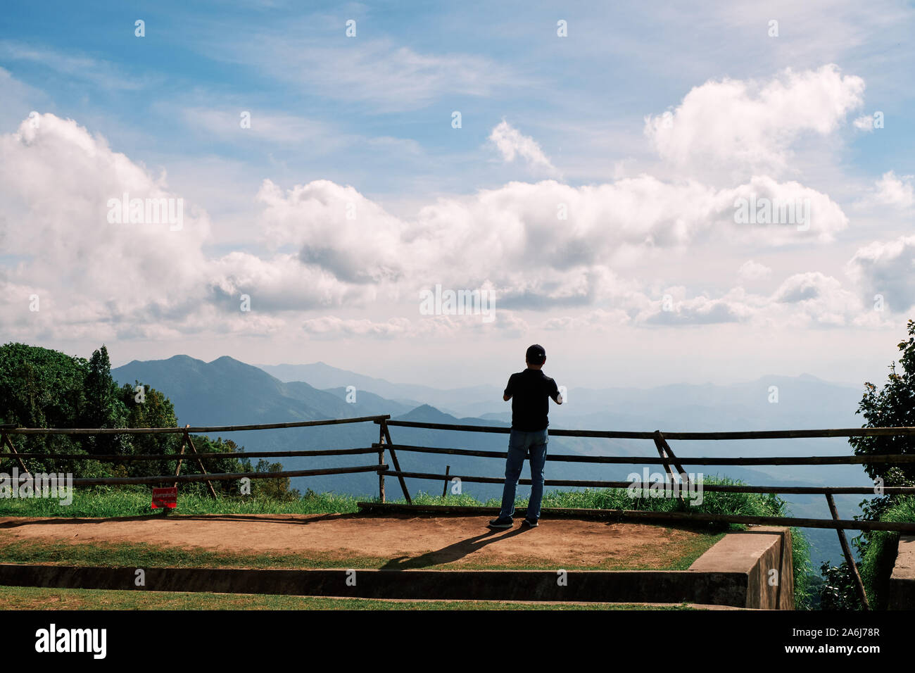 A lone photographer takes in the view of the mountainous landscape at Doi Inthanon National Park, Chiang Mai, Thailand. Stock Photo