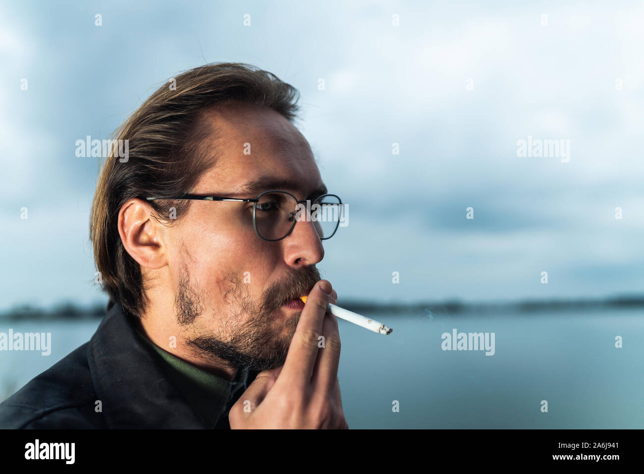 Close up photo of a man smoking a cigarette Stock Photo