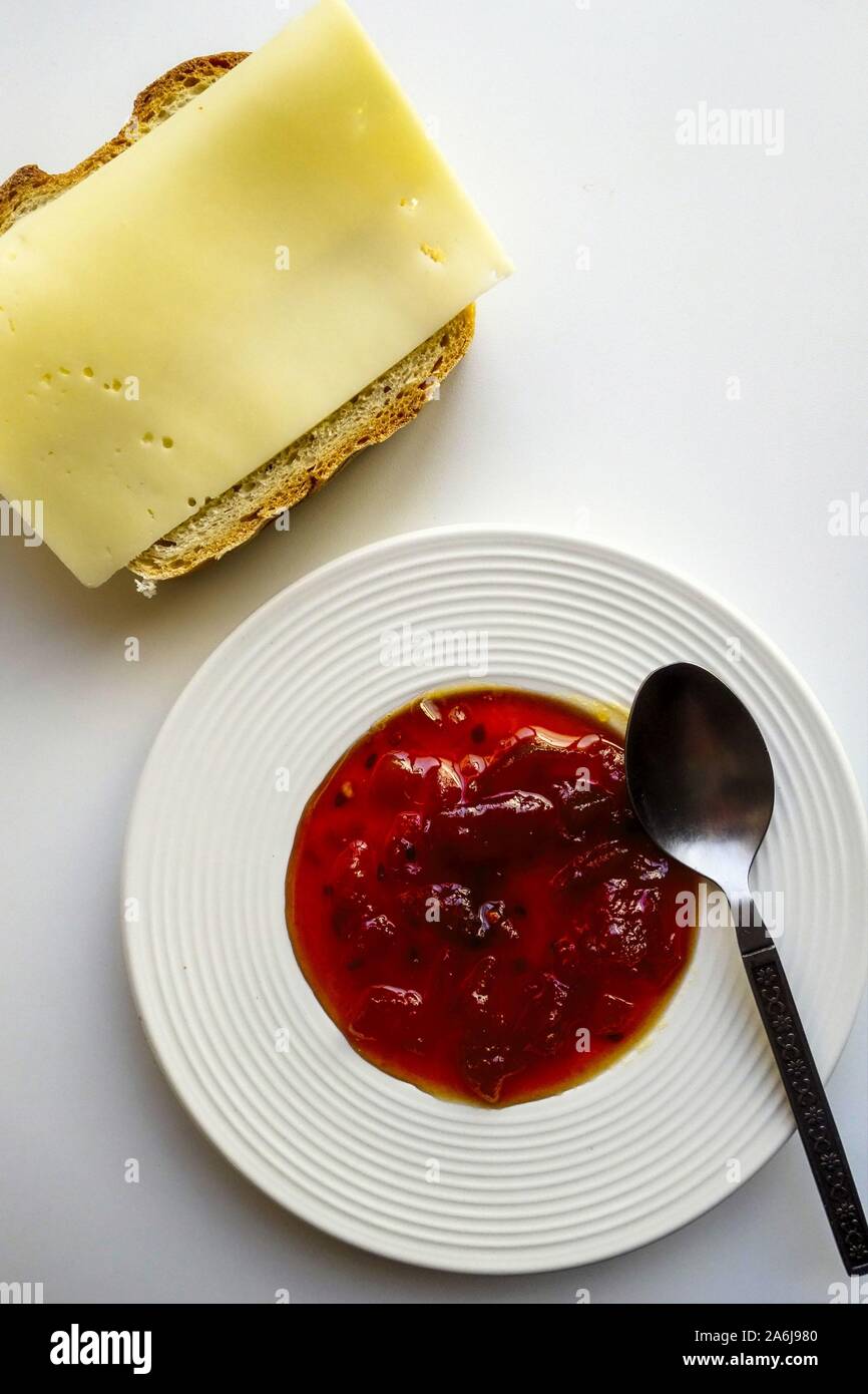 Small serving plate of Sweet Chili Jam and sliced Gouda Light Cheese on