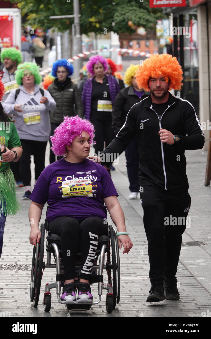 Liverpool, UK. 27th October 2019. The Arriva Liverpool Scouse 5k fun run  where everybody gets a choice of wig colour to wear on the day. Colours  include Pretty Pink, Kopite Red, Toffee