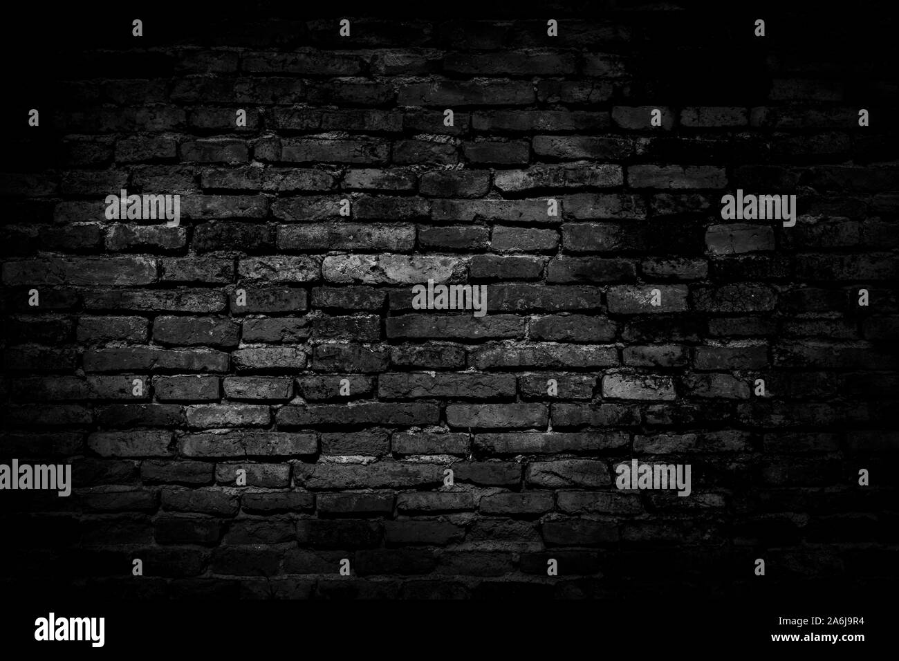 Black brick walls background and texture. The texture of the brick is black. Background of empty brick basement wall. black wall. Stock Photo