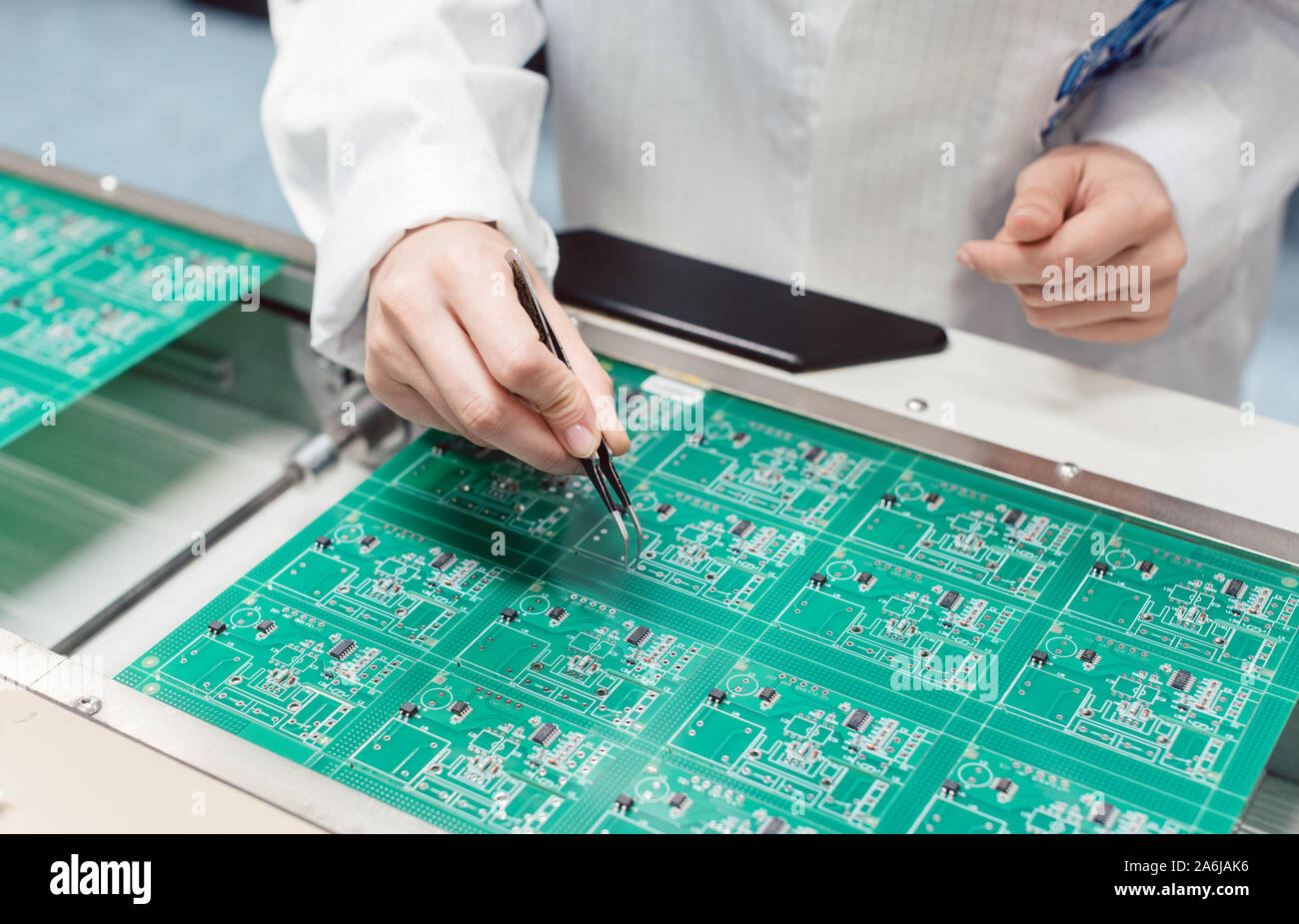 Technician assembling electronic product by inserting components into