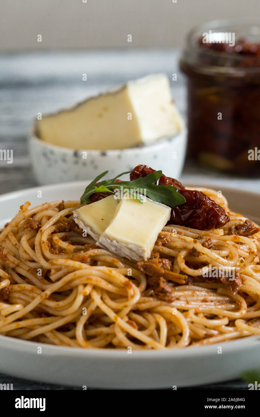 Italian Pasta with sundried tomato pesto and brie cheese Stock Photo