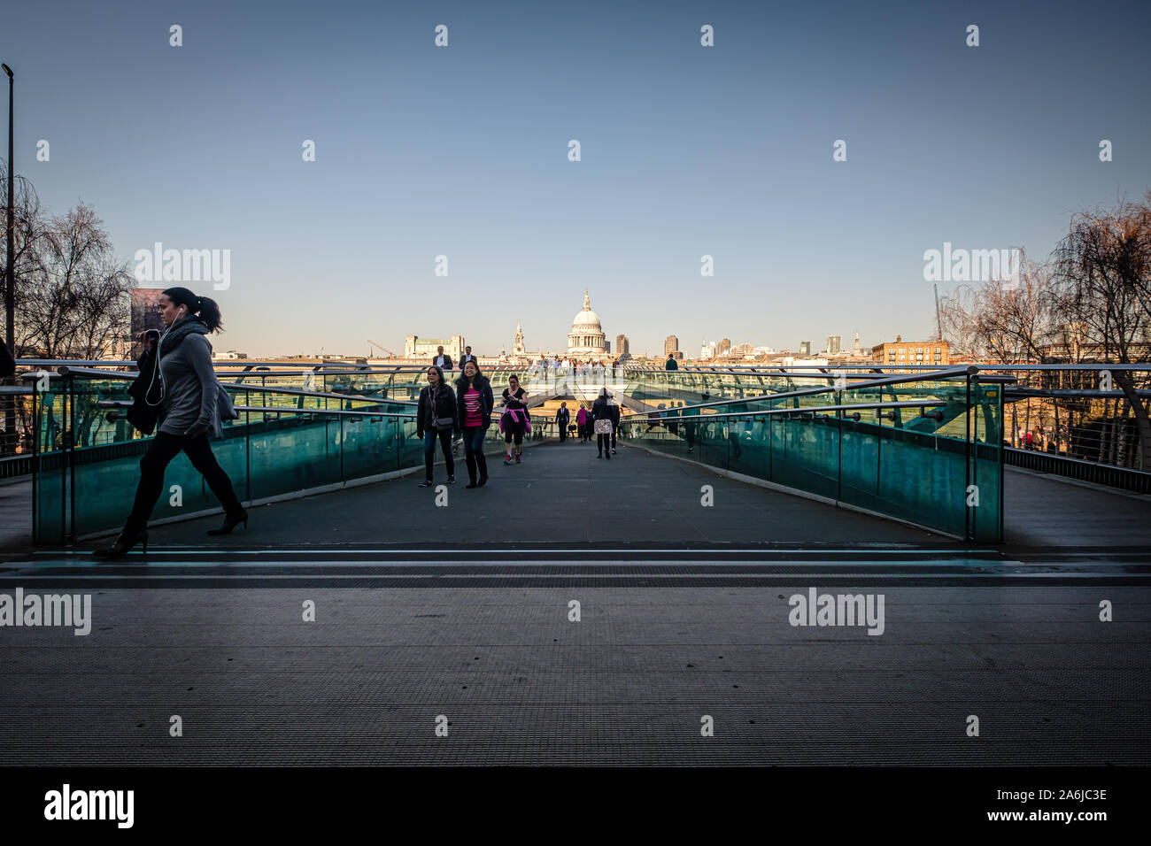 LONDON, UK, February 26, 2019: Pedestrians are walking over Millenium Bridge, St. Paul' s Cathedral beyond Stock Photo