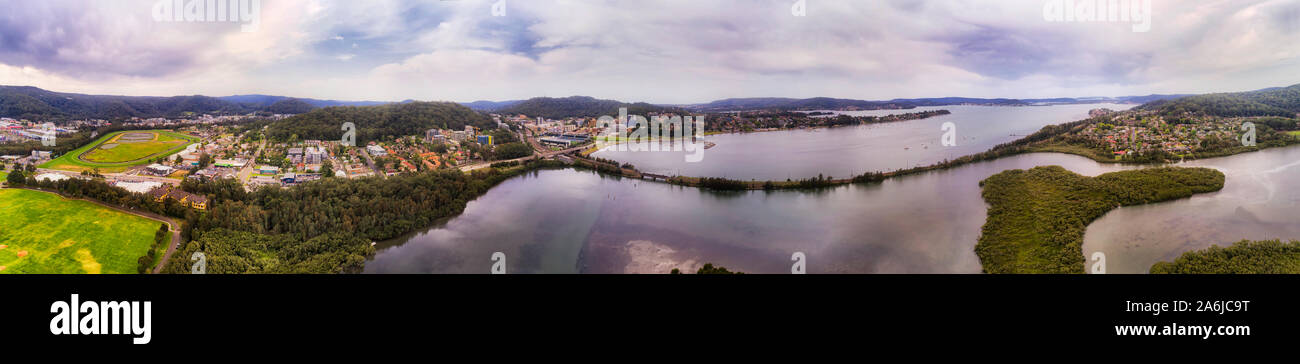 Australian Central Coast town Gosford in wide aerial panorama from race course to railway track across Brisbane water down to suburbs. Stock Photo