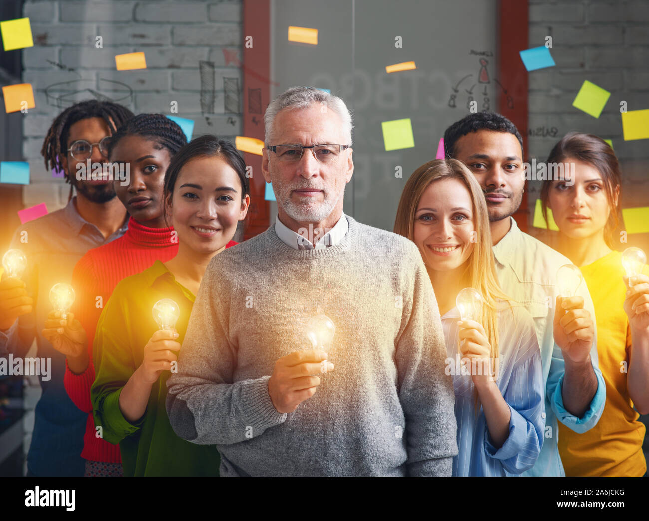 Teamwork and brainstorming concept with businessmen that share an idea with a lamp. Concept of startup Stock Photo