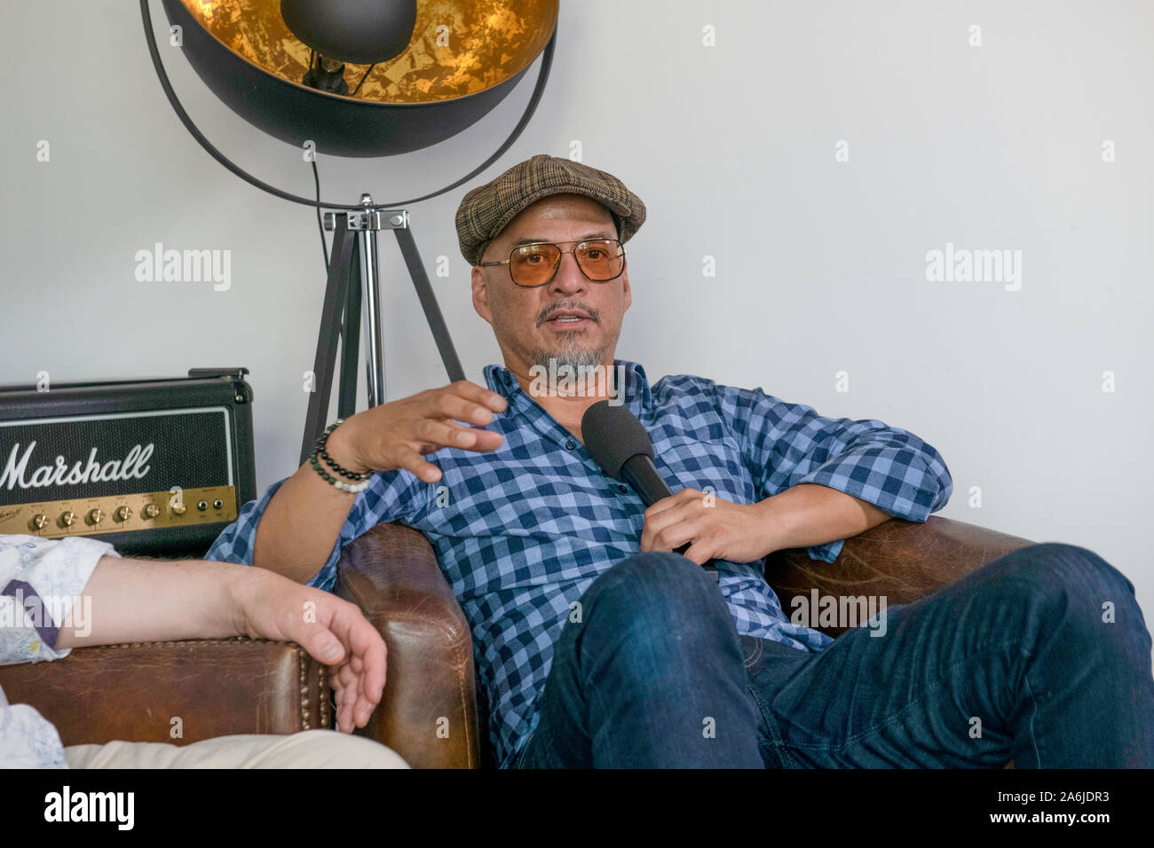 Berlin, Germany. 19th June, 2019. Joey Santiago, guitarist of the US-American band Pixies, speaks during an interview. Credit: Paul Zinken/dpa/Alamy Live News Stock Photo