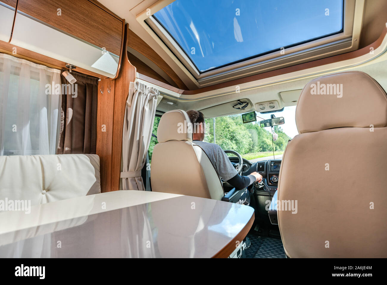 Man driving on a road in the Camper Van RV. Caravan car Vacation. Family vacation travel, holiday trip in motorhome Stock Photo