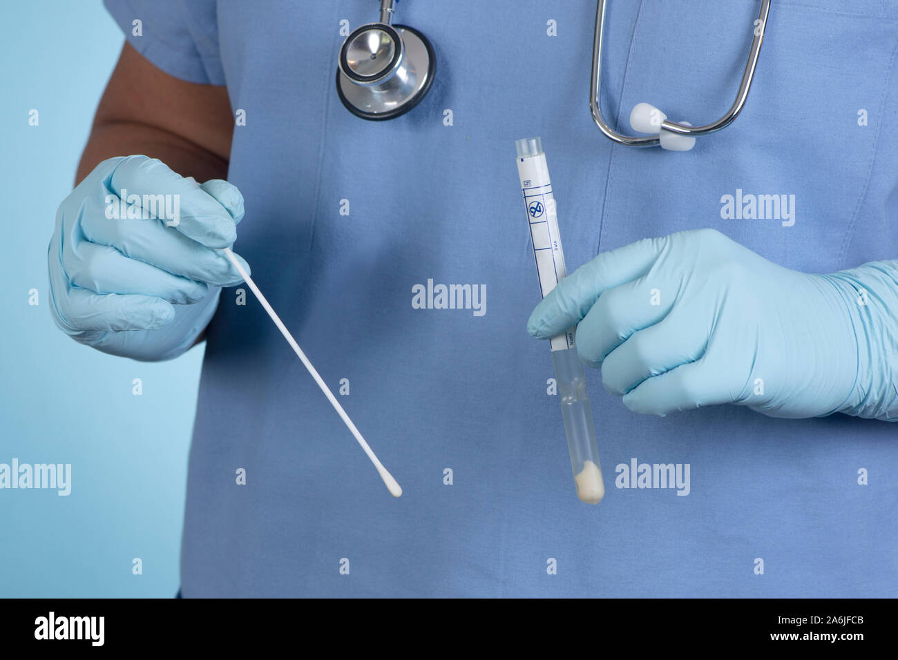 Nurse prepares culture swab and tube before taking patient sample. Stock Photo