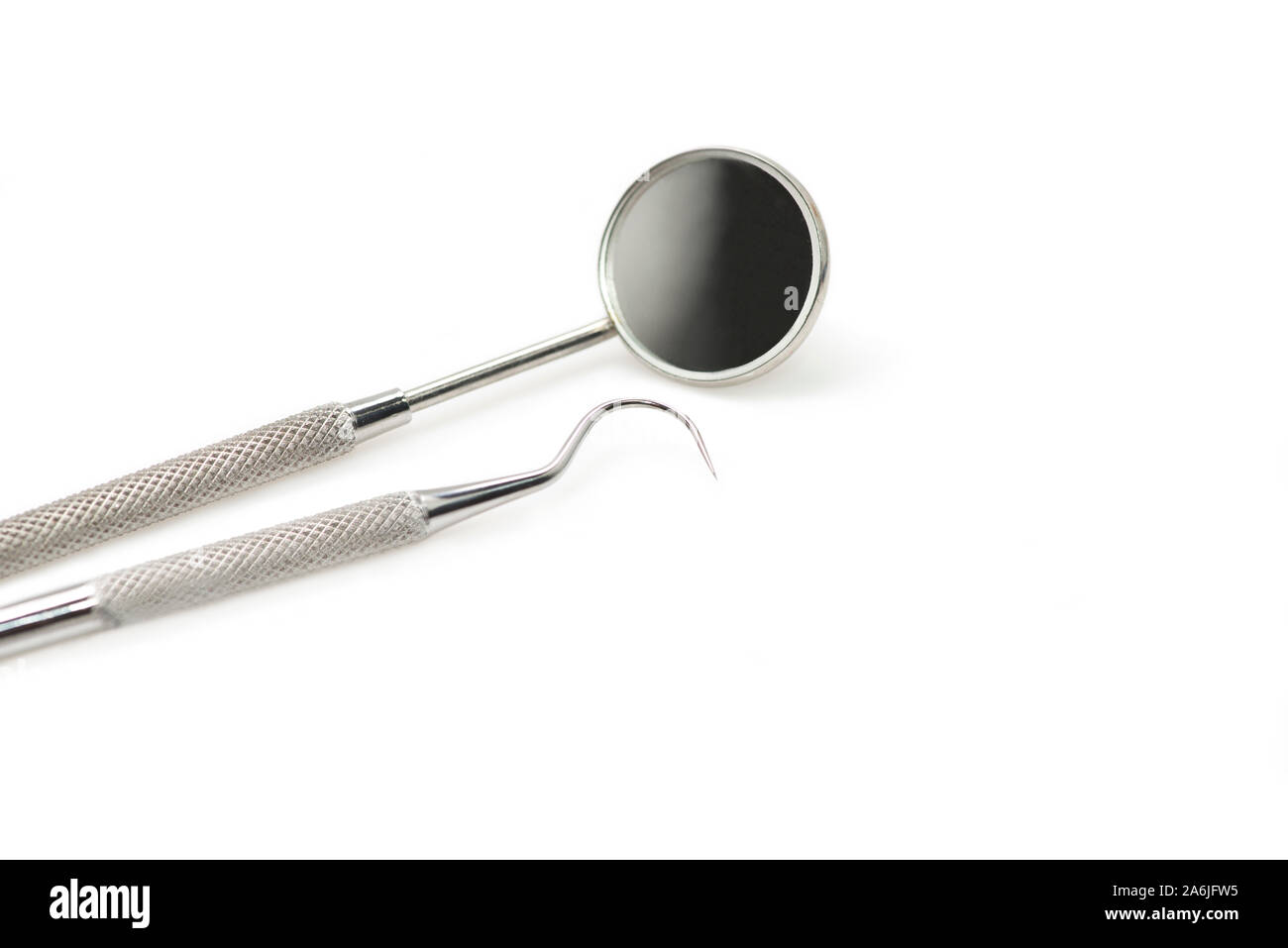 Dental mirror and pick isolated on white background with copy space