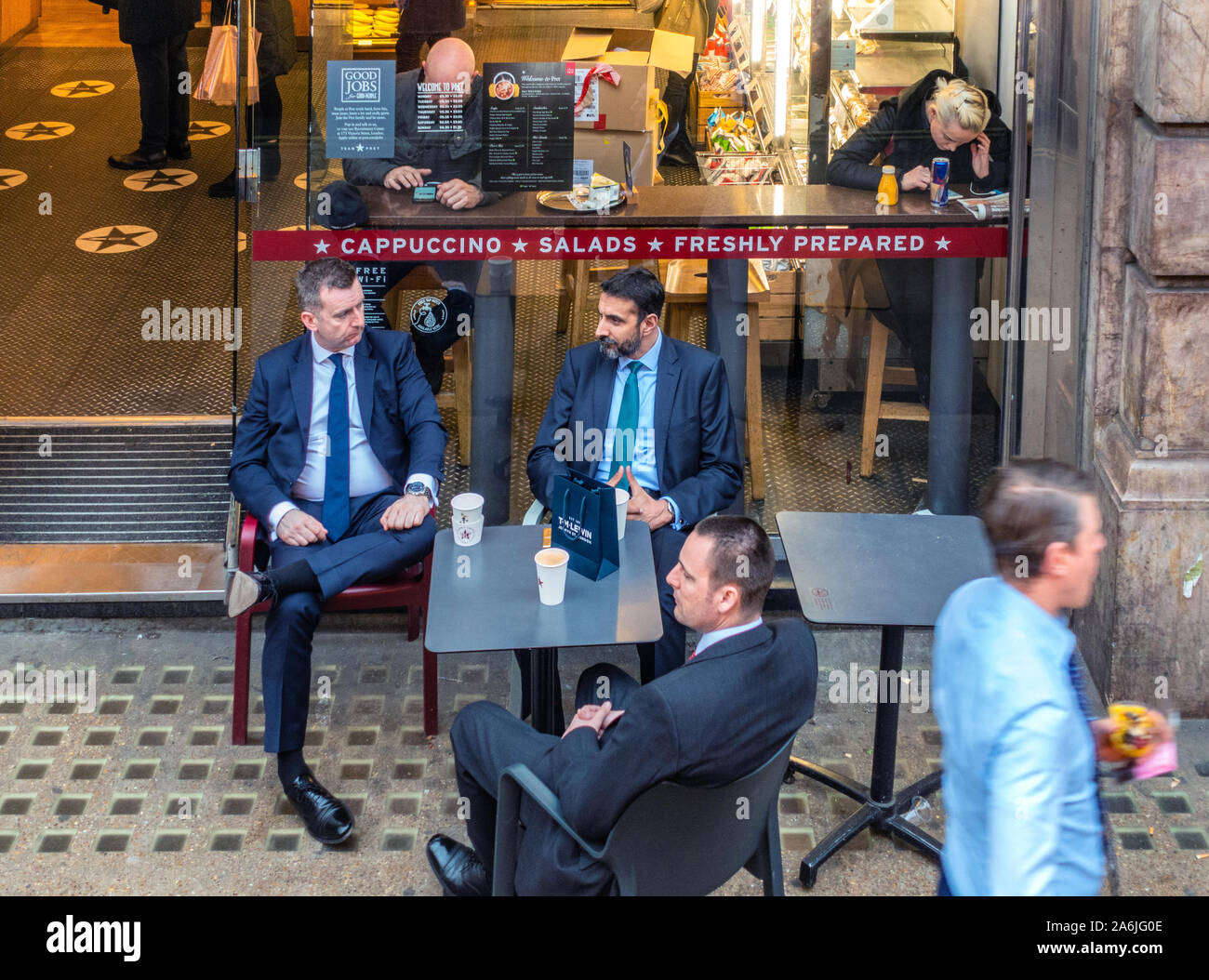 Business men chatting sitting outside at coffee shop Stock Photo