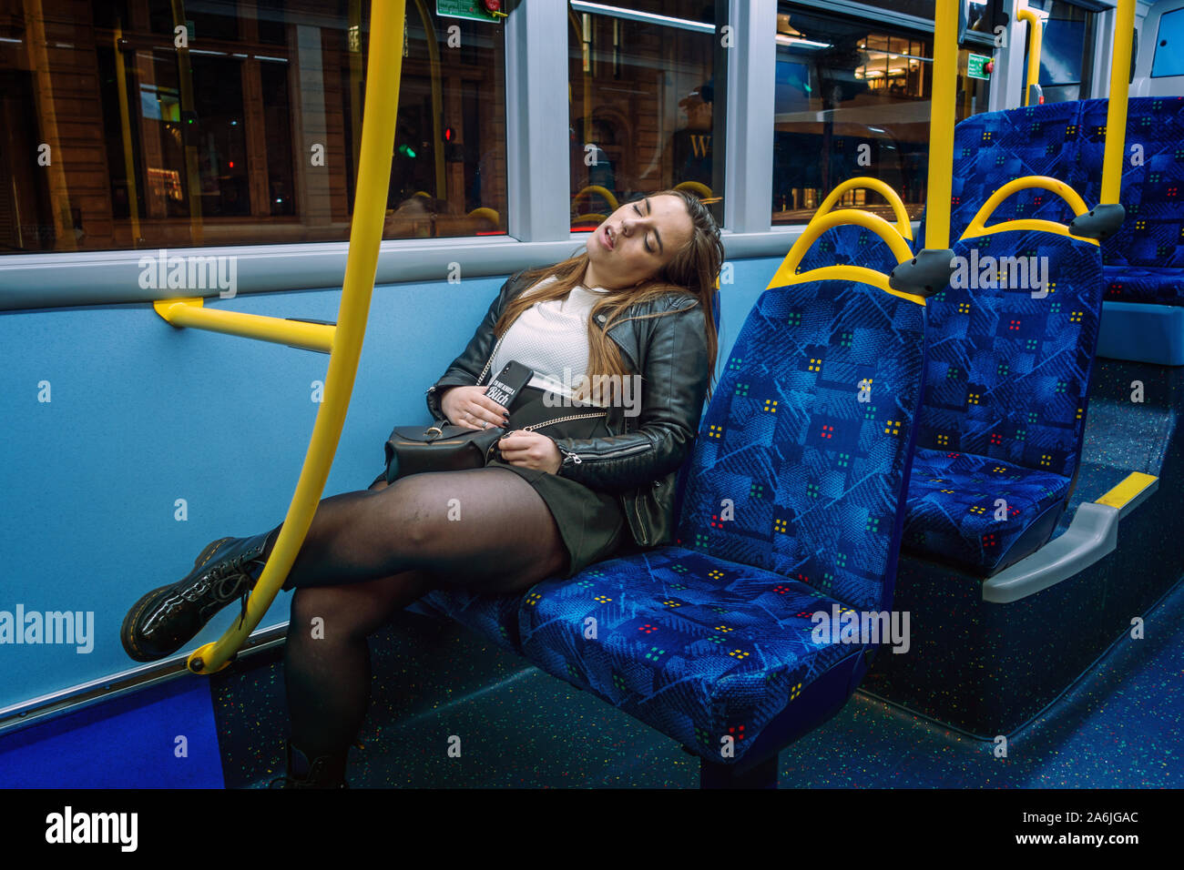 Young woman asleep on a late night bus Stock Photo Alamy