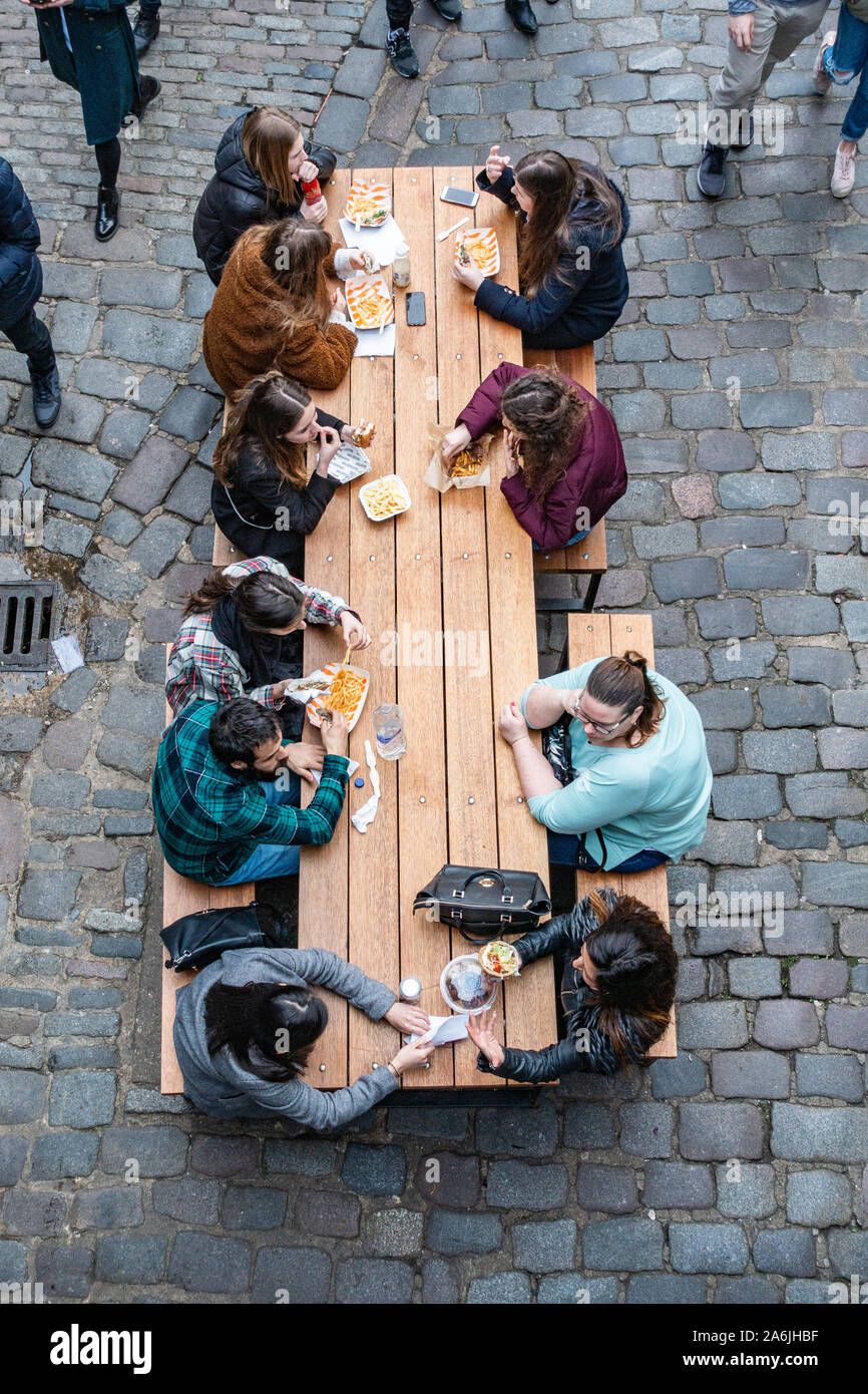 birds eye view of people eating food at a table Stock Photo