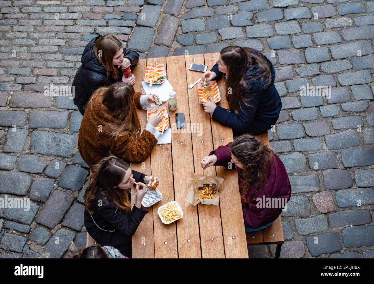 birds eye view of people eating food at a table Stock Photo