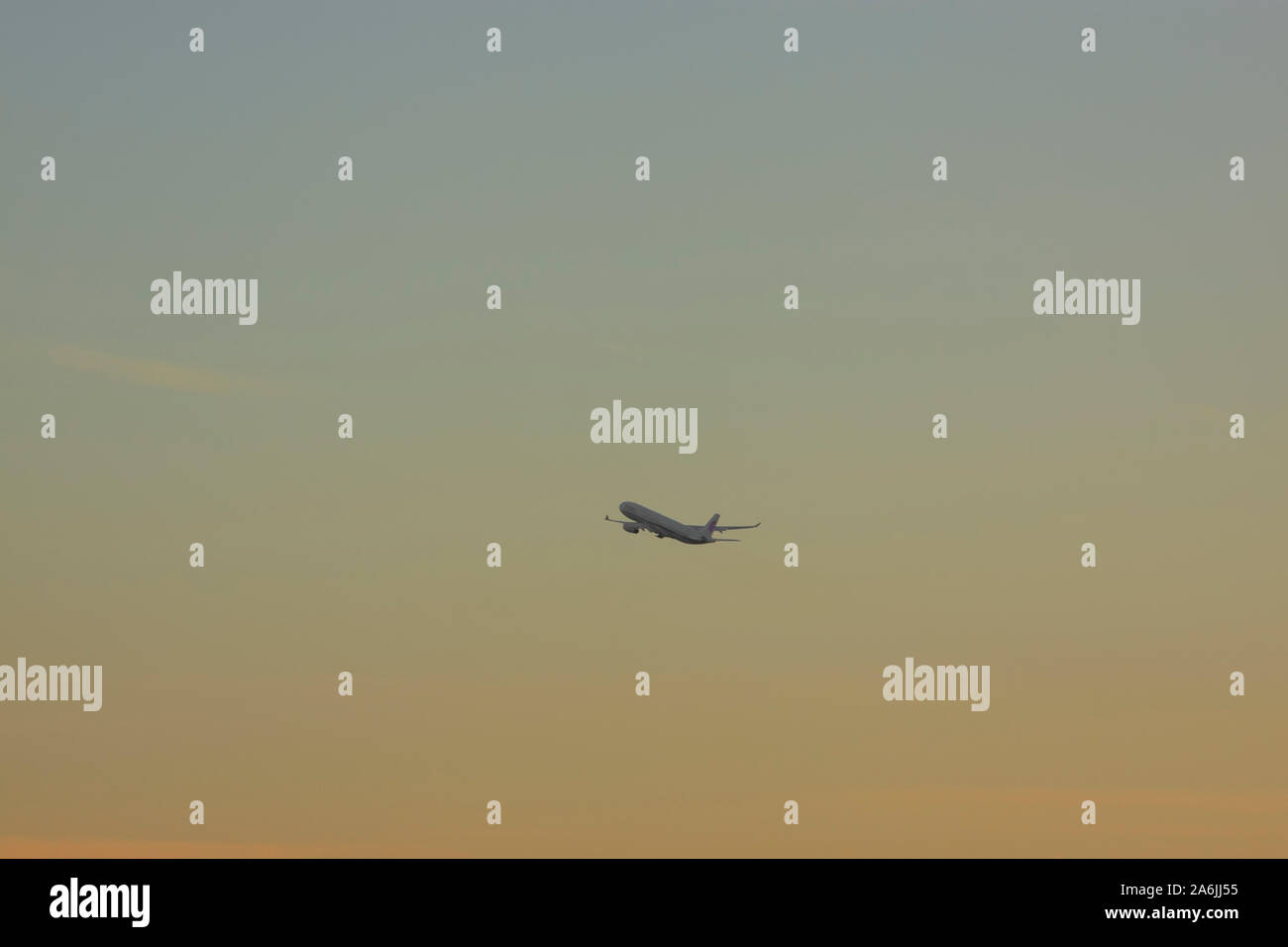 Airplane taking off in sunset Stock Photo