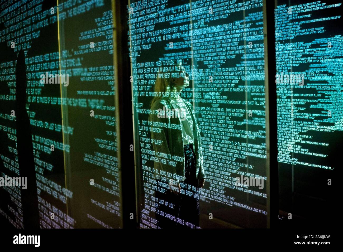 A staff member looks at a three dimensional projection 'Awake' by Tekja, 2019, which features live data from around the world that tracks insomnia, during the press preview of the winter art exhibition at Somerset House, the Strand, London, entitled 24/7: A Wake-Up Call For Our Non-Stop World. The exhibition shows a series of immersive works, from a global range of artists, examining our inability to switch off from 24/7 culture. Stock Photo