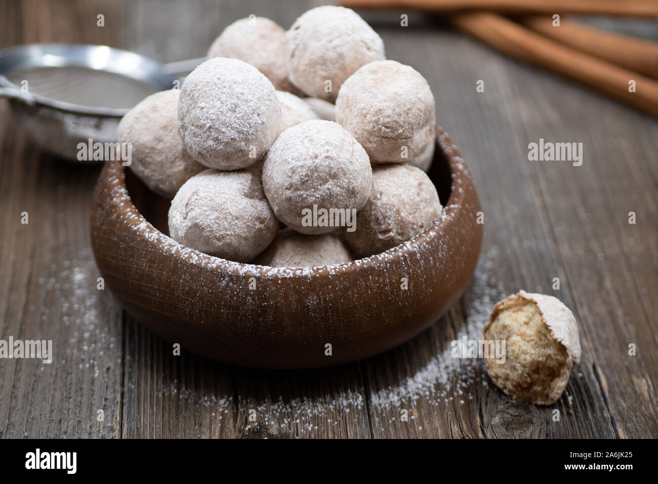 Wooden bowl with apple and spice donut holes, sprinkled with cinnamon sugar Stock Photo