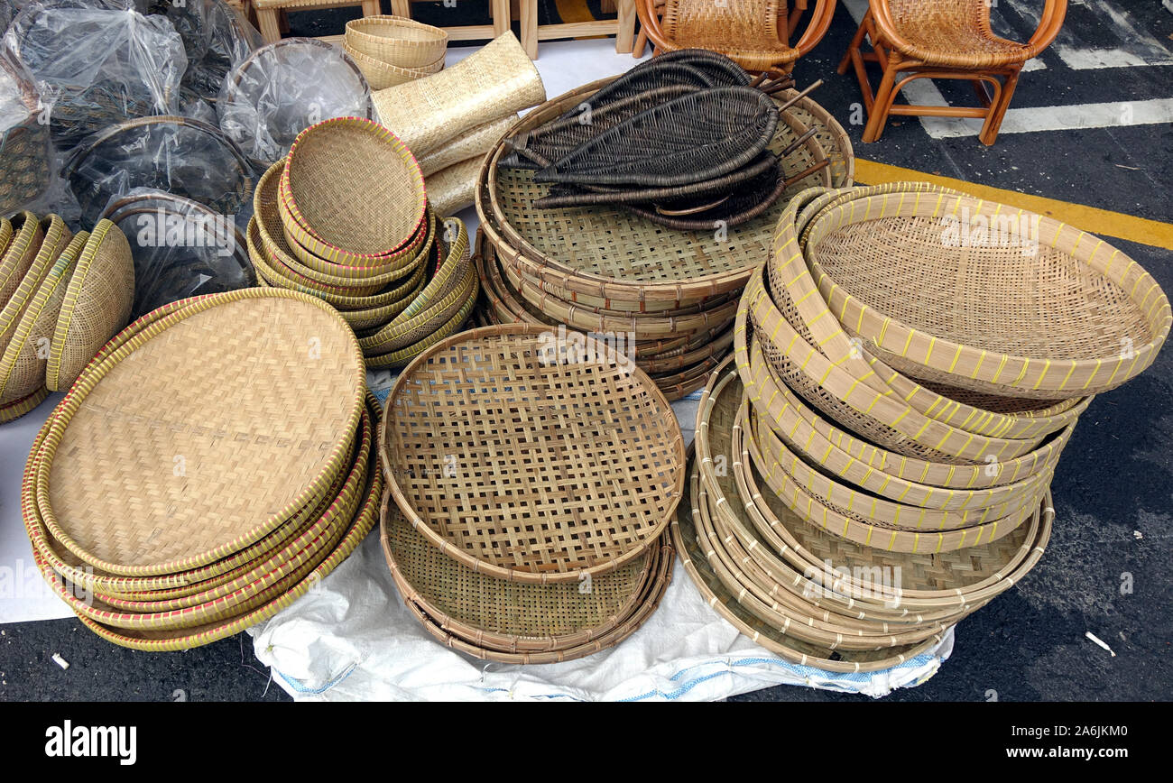 Handcrafted wicker baskets and trays at an outdoor market Stock Photo