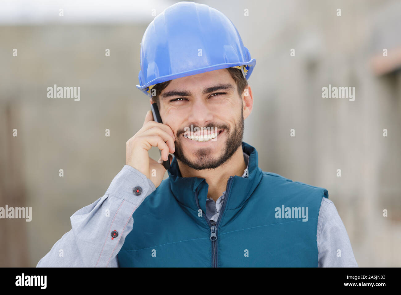 happy young engineer using mobile phone Stock Photo