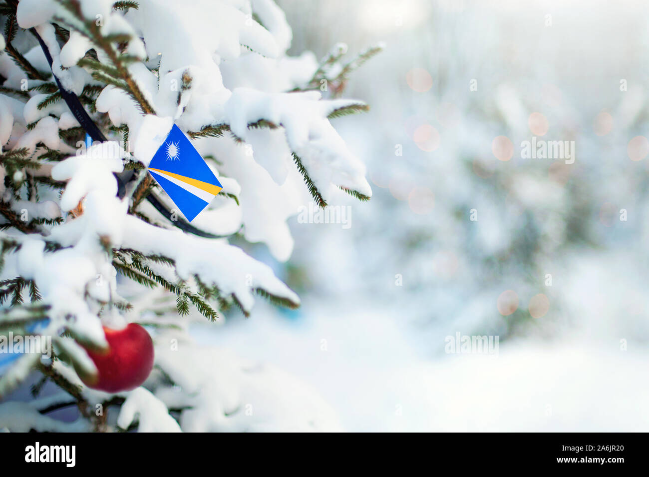 Christmas Marshall Islands. Xmas tree covered with snow, decorations