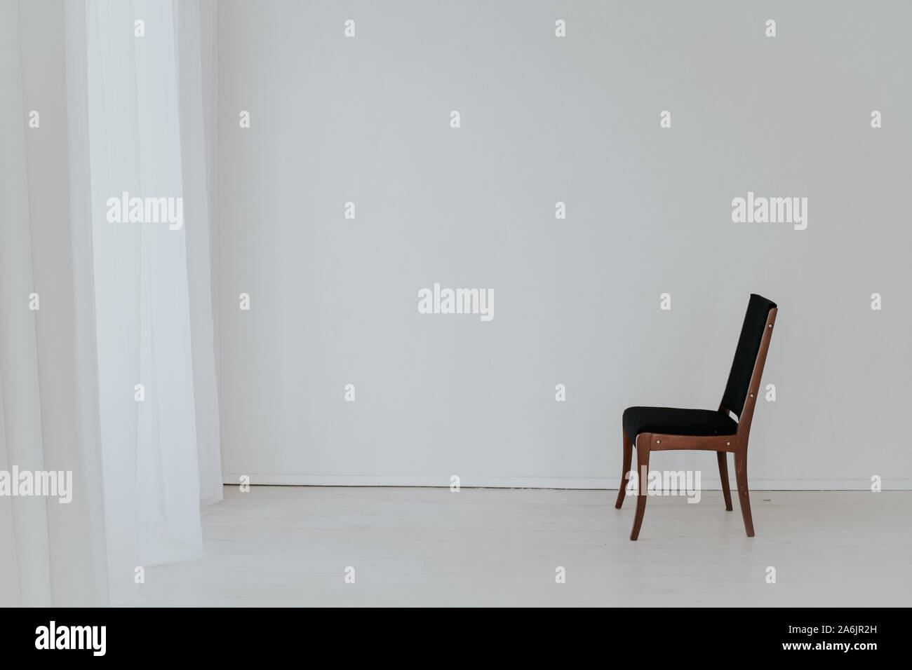 one black vintage chair in an empty white room Stock Photo - Alamy