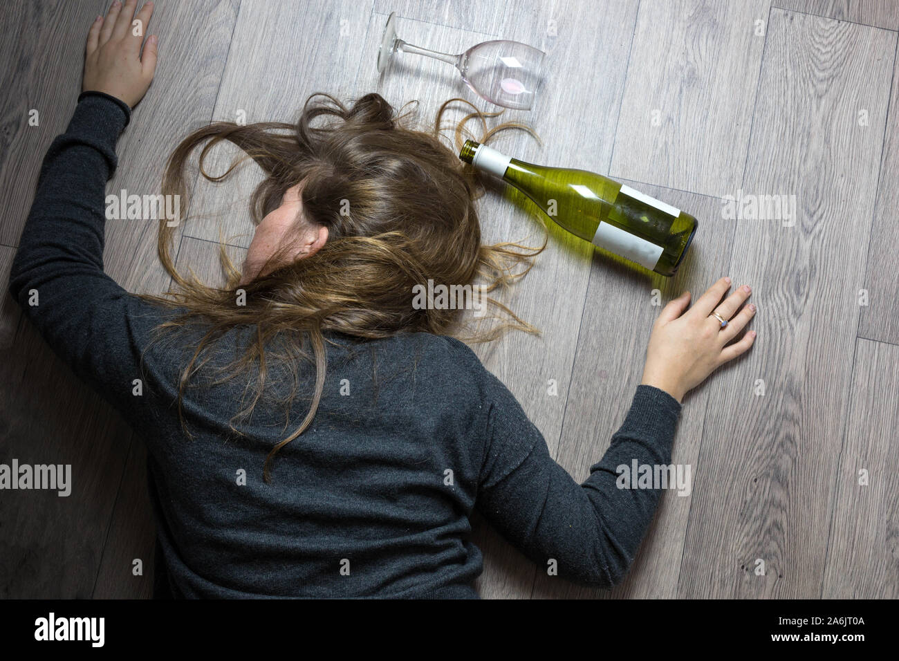 Girl With A Bad Appearance, In A Bra And Mask For Sleeping, Holds A Bottle  Of Alcohol And Looks At It. Stock Photo, Picture and Royalty Free Image.  Image 92392163.