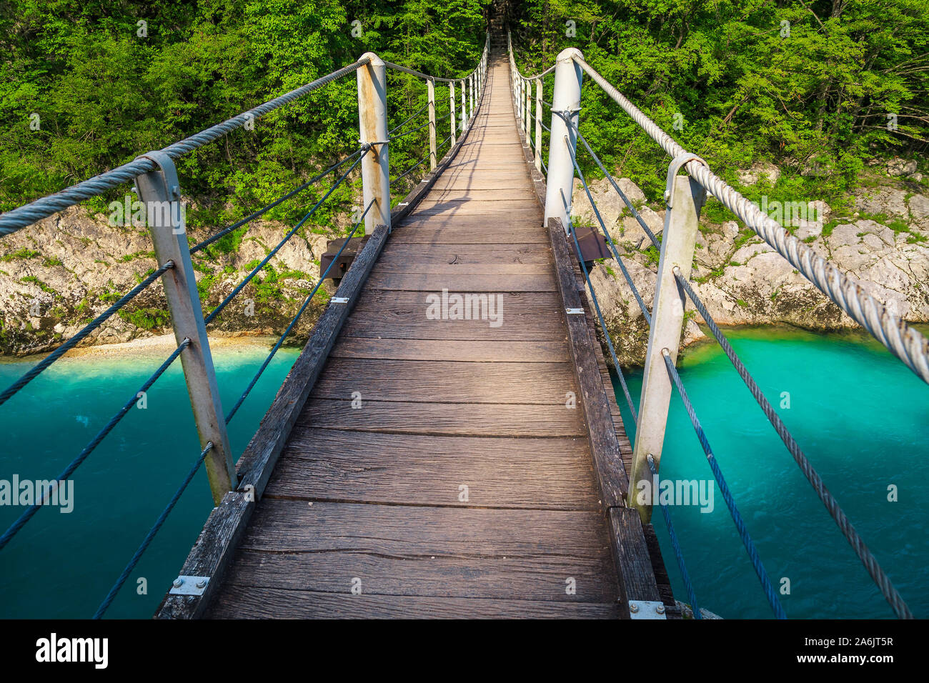 Fantastic touristic place with clear river and bridge. Spectacular suspended wooden bridge above the Isonzo river in Soca valley, Kobarid, Slovenia, E Stock Photo