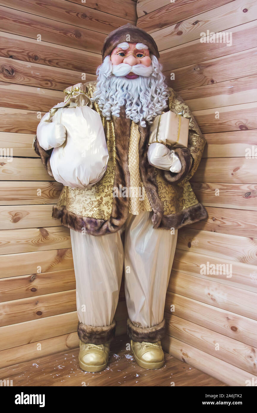 big toy santa claus. life-size puppet on a wooden background Stock Photo